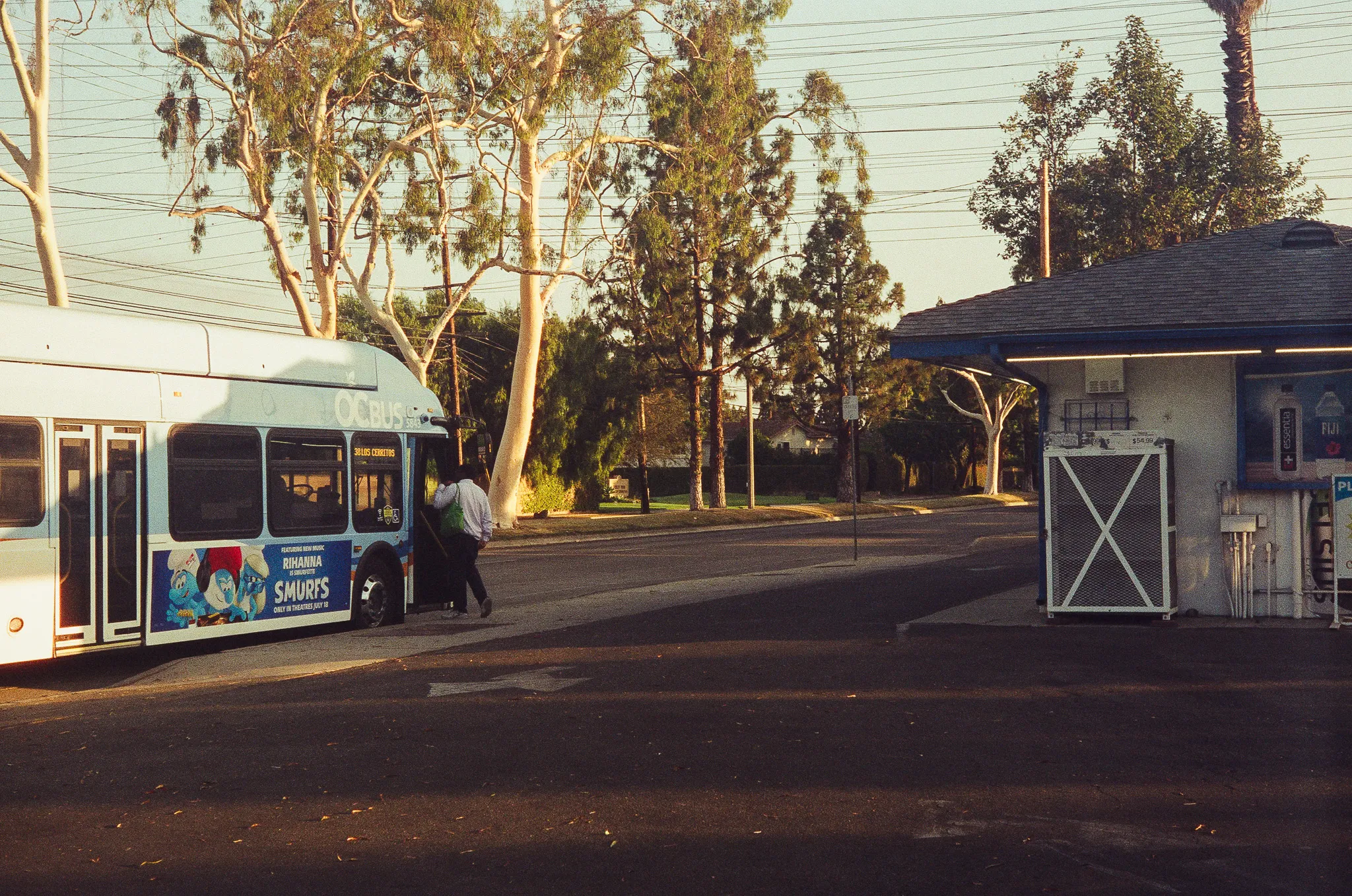The bus stops in front of Jersey Gold, picking up a worker